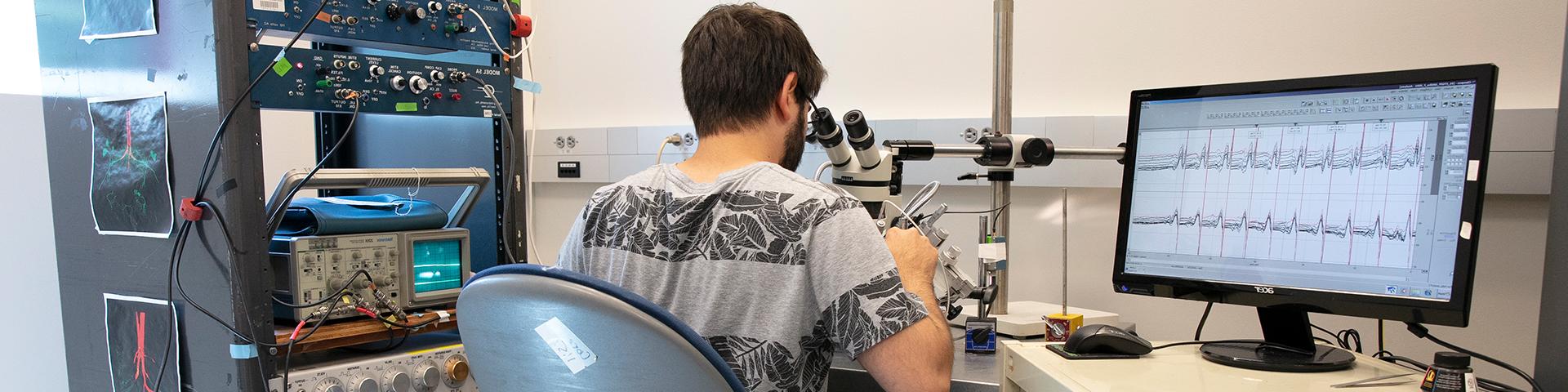 Student looking into a microscope